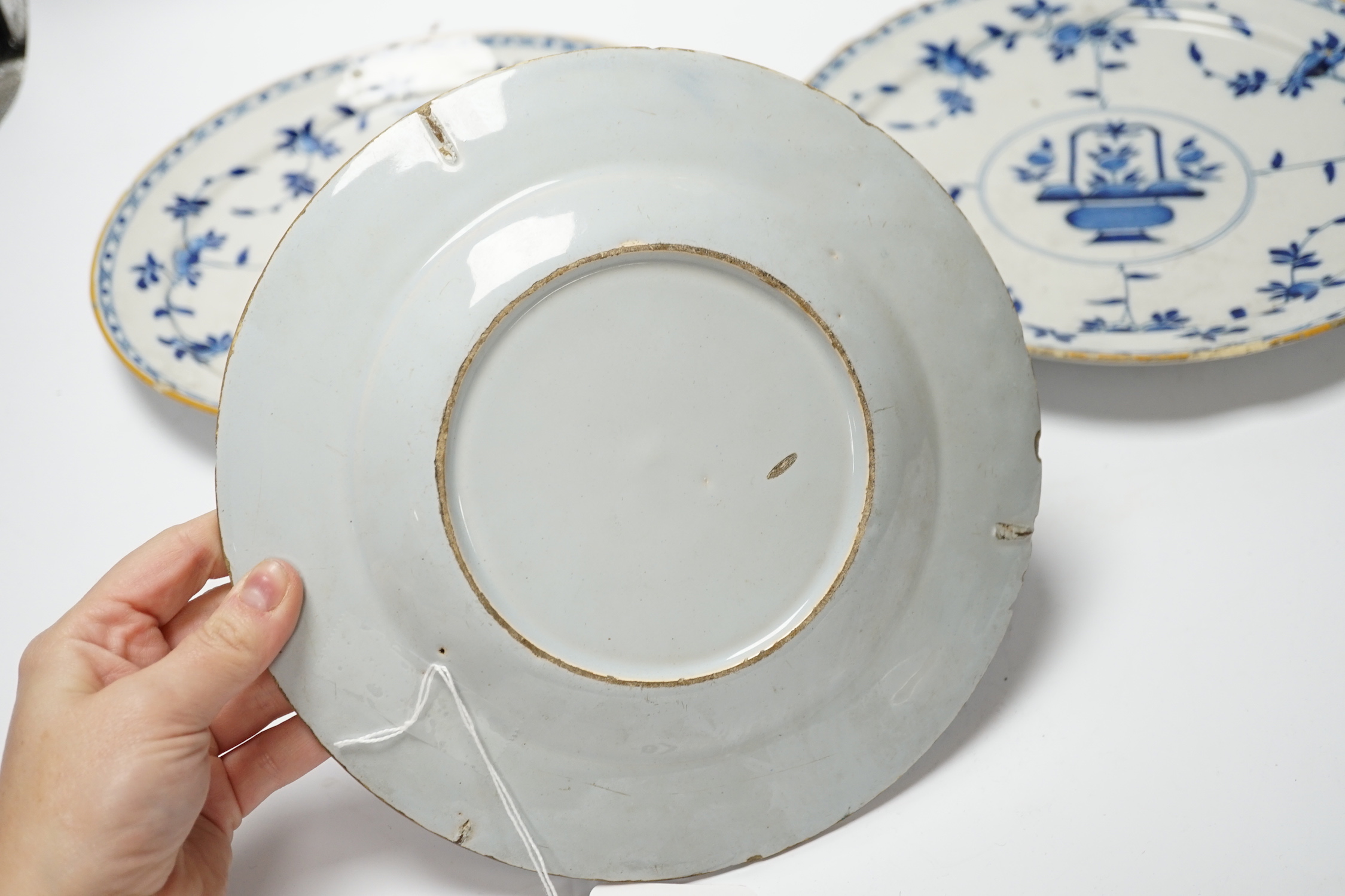 A pair of late 18th century Delft plates and an English delftware plate (3)